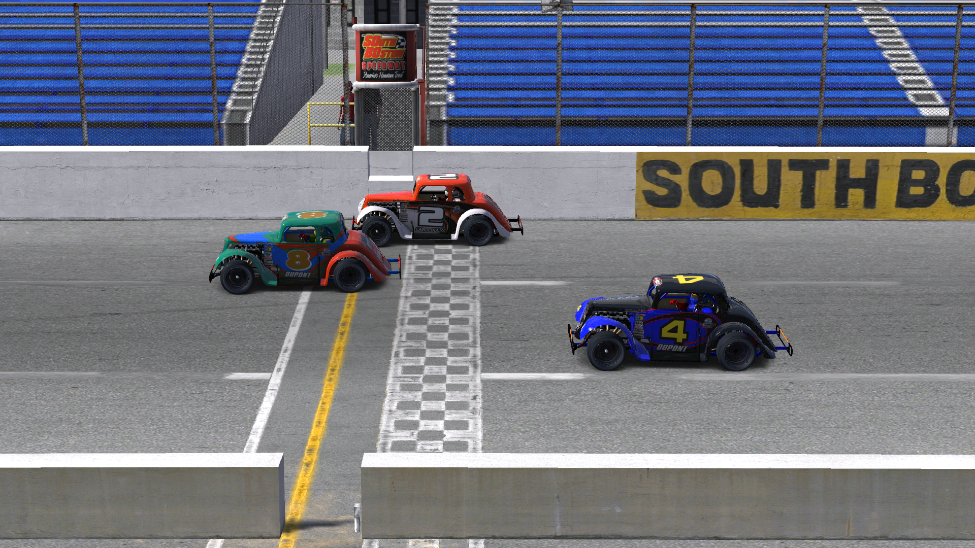 A close finish in my first oval win as I (#2 car, top) edged the #4 while negotiating lapped traffic (#8).